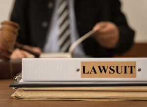 Lawyer reviewing lawsuit files on his desk.