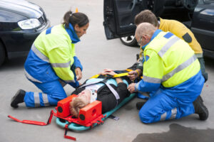 Injured victim from car crash rescued by paramedics.