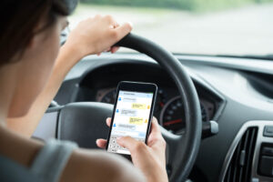 Teen driver is texting while driving.