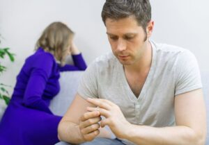 Husband taking off his wedding ring.